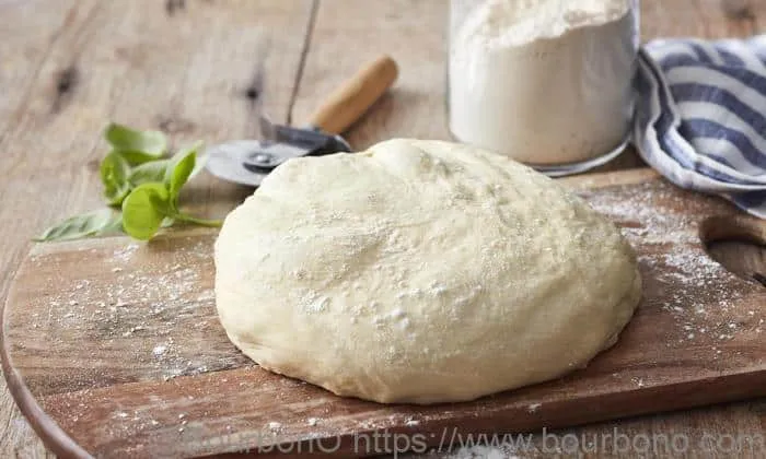 Transfer the dough for the Godfathers Taco Pizza recipe onto the surface sprayed with flour