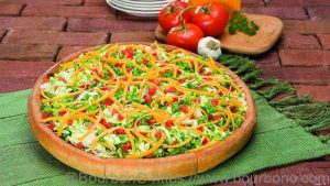 Serve the Godfathers Taco Pizza recipe with shredded lettuce and chopped tomatoes