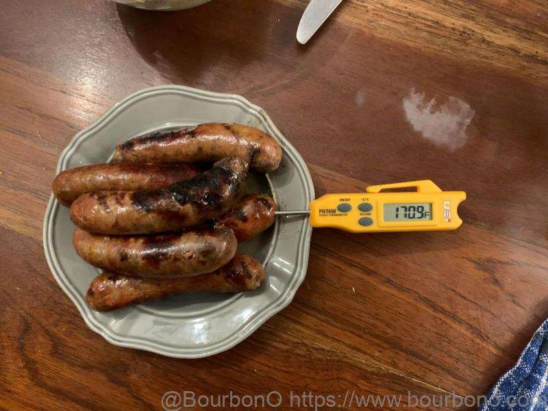 Pierce the tip of the thermometer into one end of the sausage