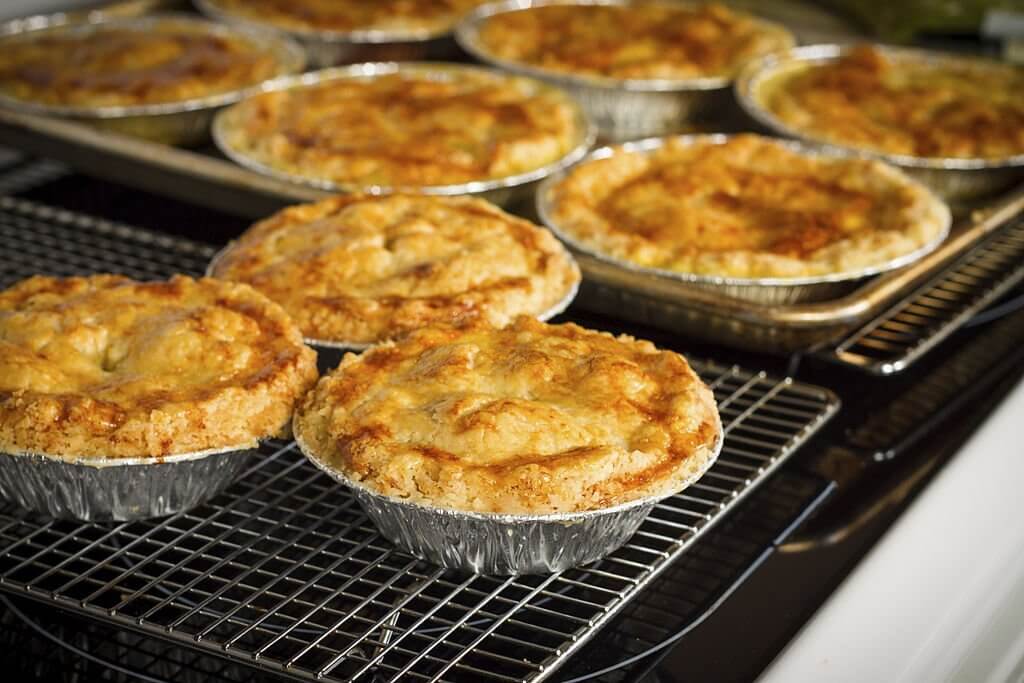 meat pies placed on a rack to cool